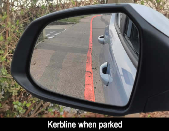 View of left, passenger door mirror when parked next to the kerb